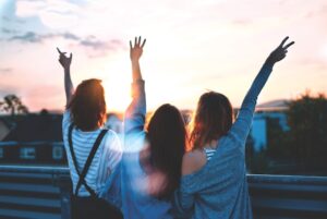 Mujeres celebrando mirando el atardecer